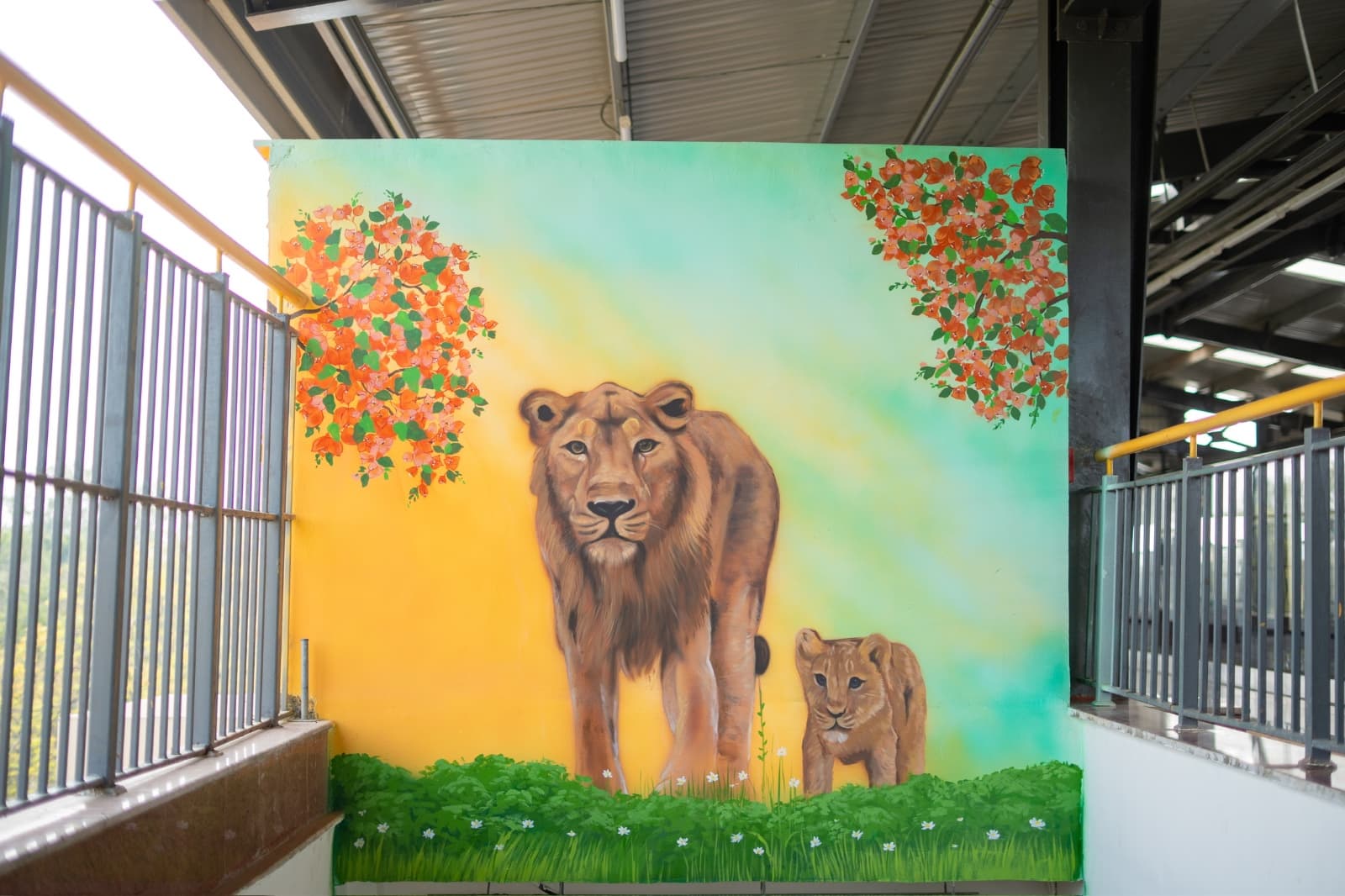 Realistic mural of a lioness and cub painted on a metro station corridor wall