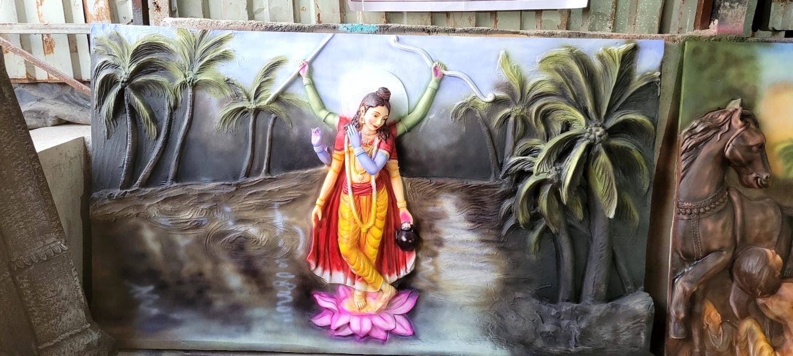 FRP relief panel of a multi-armed goddess figure standing on a lotus