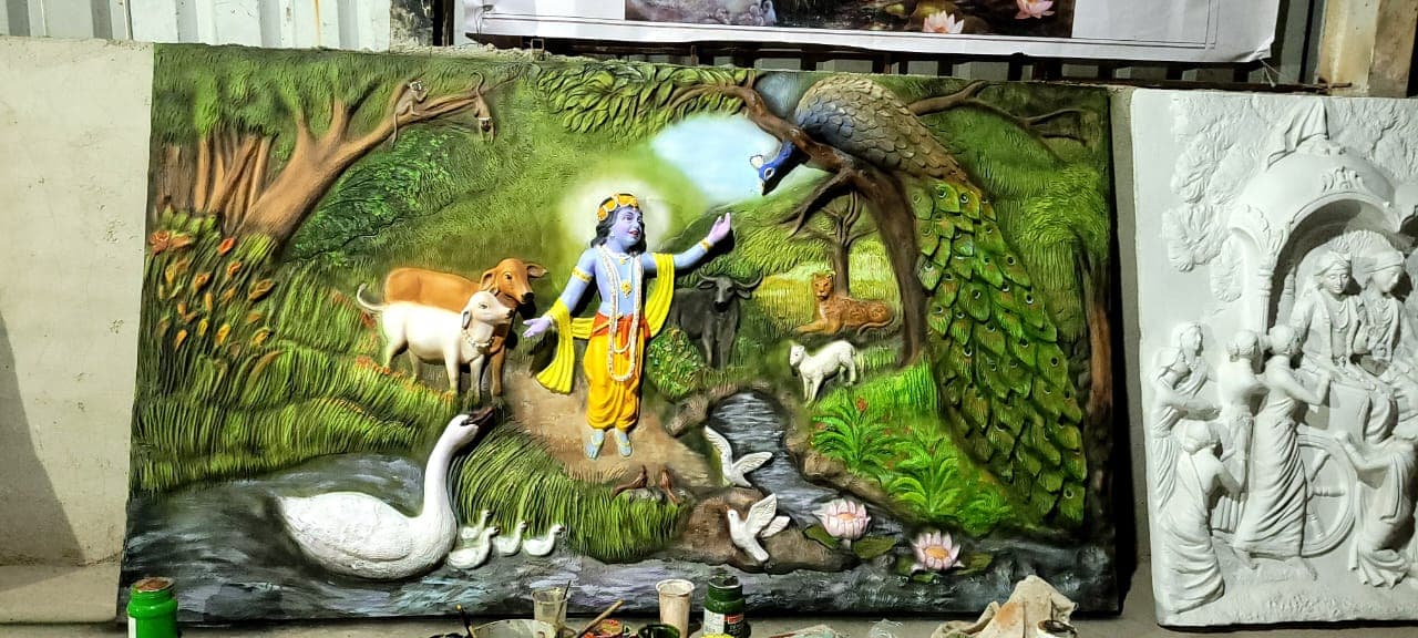 FRP relief panel of Krishna in a forest setting with cows, a peacock and a swan