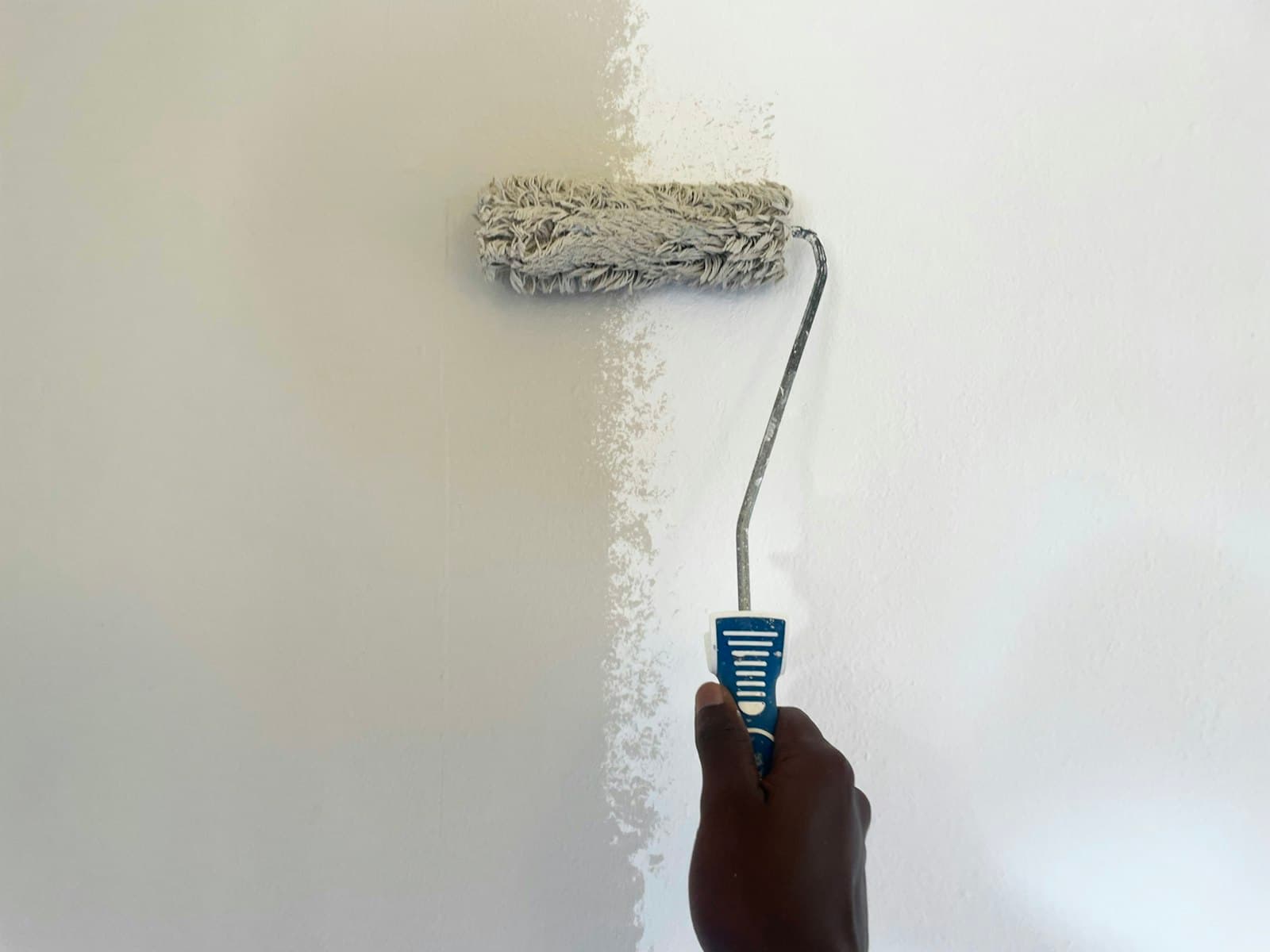 Professional painter applying paint with a roller